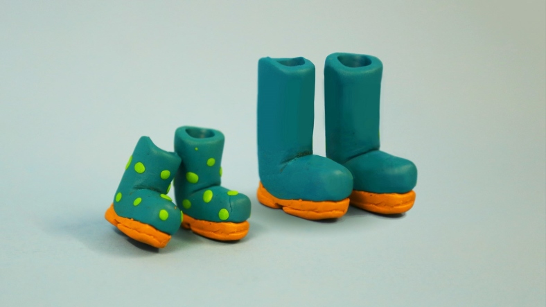 Plasticine model of child and adult pair of boots